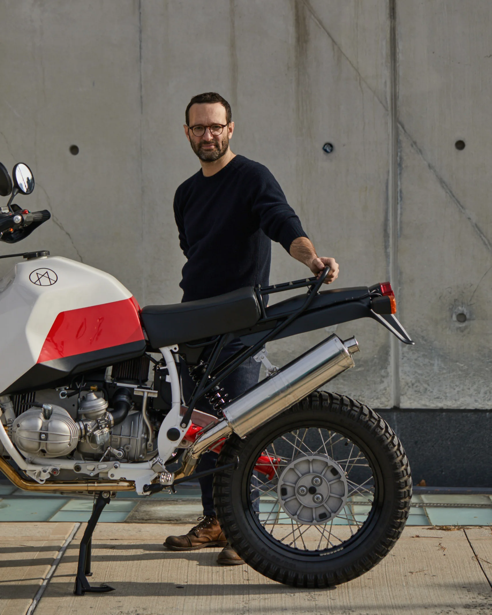 Matias Corea standing beside a Myth motorcycle