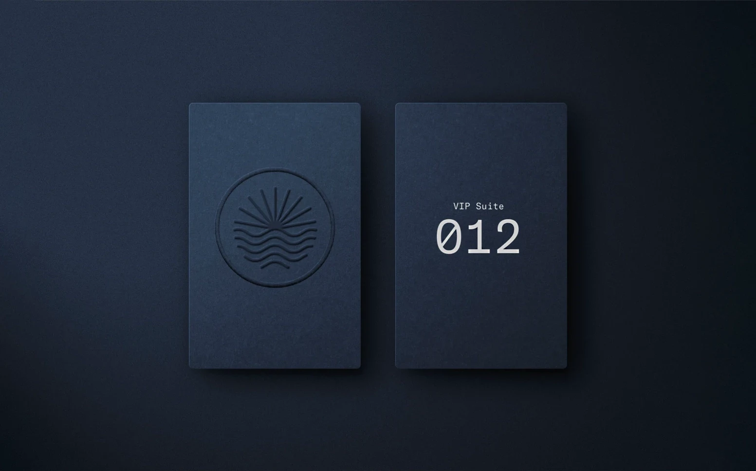 Infinite Jest sun-and-water emblem and VIP Suite 012 cards in dark blue